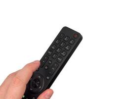 White male hand on white background presses buttons on TV remote control, TV channels remote control, for banners, for TV advertising. Copy space, flay lay, top view. photo