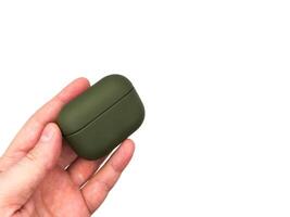 Wireless headphones in green case on a white background. copy space photo