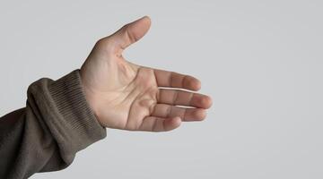 hand extends upwards in a welcoming gesture against a neutral background. photo