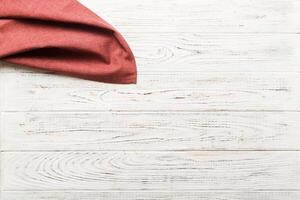 top view with empty kitchen napkin isolated on table background. Folded cloth for mockup with copy space photo