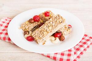 Various granola bars on table. Cereal granola bars. Superfood breakfast bars with oats, nuts and berries, close up photo