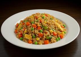 A plate of fried rice with vegetables and carrots photo