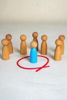 The man is separated from the crowd by a red line. Isolation from society. Safety and personal boundaries. Mental health, introversion, or creating healthy limits. Societal rejection photo