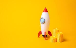 Rocket and a stack of coins. Startups and advertising. Space race. Business launches, venture capital, or bold marketing investments. Space exploration, innovation, risk taking in emerging industries. photo