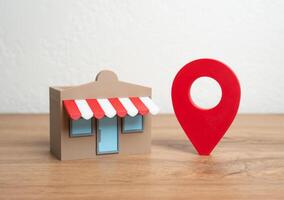 Shop and red geolocation sign. Advertising and presenting your business on maps and social networks. Geotargeting, SEO for businesses, or location-based customer acquisition. photo