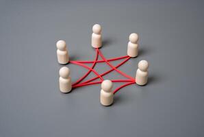 People in a circle are connected by lines and connections. Teamwork, digital connectivity, or interlinked systems. Networking, social interaction, corporate structures, or tech ecosystems. photo