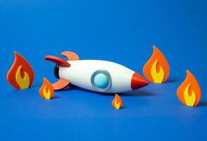 Space rocket crashed and on fire. Business failure, failed startup. Downfall of ambitious plans, flawed execution, or crisis outcomes. Volatility of startups, financial risks, or unexpected setbacks. photo