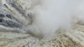 Aerial view of immense Iguazu Falls with roaring water plunging into mist below video