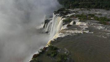 Iguazu Falls stunning river drop with cliffs and rising mist in natural wonder video