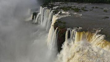 Aerial view Iguazu Falls rainbow in spray above powerful river and falls video