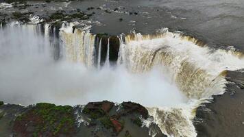 Powerful waterfalls of Iguazu Falls plunge into canyon with thick white mist video
