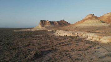 Dramatic butte and arid steppe landscape at Aktumsuk, Uzbekistan during dusk video
