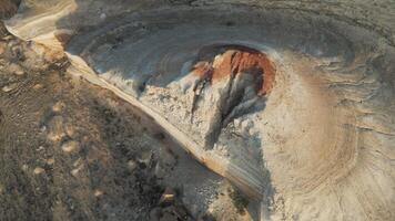 Aerial view of Aktumsuk's unique round erosion crater with colored slopes video