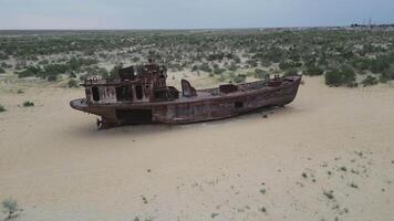 Abandoned rusting ship stranded on desert sands of Muynak video