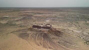 Khorezmian ruins seen across desert horizon from high altitude video