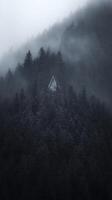 A-Frame Cabin nestled in a Foggy Mountain Forest. photo