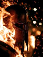 Fiery Spartan Helmet A Dramatic Close Up of Ancient Armor Surrounded by Flames. photo