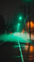 Foggy Night Street Scene with Green and Orange Streetlights. A mysterious and atmospheric image of a city street at night, shrouded in fog and illuminated by contrasting colored lights. photo