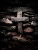Weathered Wooden Cross nestled in a Stone Wall. A dark and moody image perfect for religious or spiritual themes. photo