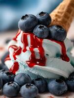 Close Up of Blue Ice Cream with Fresh Blueberries and Red Sauce. photo