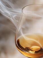 Amber Liquid in a Glass with Swirling Smoke. A close up image showing the details of a drink. photo
