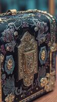 Close up of an Ornate Handbag with Intricate Gold Accents and Floral Designs. photo