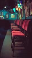 Row of Red Chairs in a Dimly Lit Bar, Close Up. Awaiting Patrons. photo