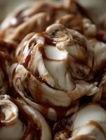 Close Up of Creamy Ice Cream with Caramel Sauce Swirls. photo