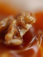 Close up of Walnuts in Caramel Sauce A Delicious Treat. photo