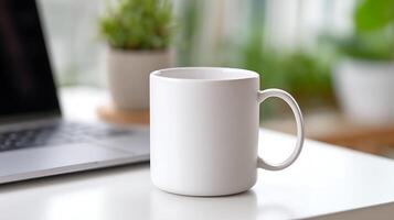 Blank White Mug on a Desk next to a Laptop. A simple, clean image perfect for branding and design projects. photo