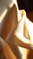 Draped Fabric in Warm Golden Light Abstract Textured Background. photo