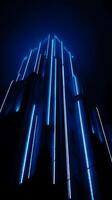 Night cityscape A low angle view of a building illuminated with vibrant blue neon lights. photo