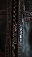 Close up of a Leather Zipper Detail with Orange Stitching. A detailed image showing the texture and craftsmanship of a high-quality leather garment. photo