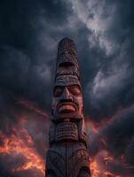 Native American Totem Pole at Sunset, Dramatic Sky Background. photo