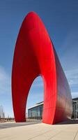 Modern Red Architectural Sculpture against a Blue Sky. A striking image of a contemporary art installation. photo