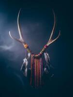 Antler Dreamcatcher with Colorful Beads and Feathers. A close up image of a handcrafted dreamcatcher made from antlers, beads, and feathers. photo