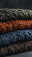 Stack of Cozy Knitted Sweaters in Earthy Tones. A close up image showcasing the texture and warmth of autumnal colored knitwear. photo
