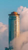 Modern Skyscraper Emerging from Fog, Cityscape Architecture. photo