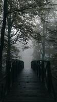 Mystical Foggy Forest Path A Wooden Bridge Leading into the Mist. photo