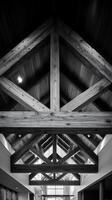 Architectural Detail Black and White Image of Exposed Wooden Beams in a Modern Building. photo
