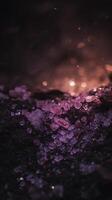 Close Up of Pink and Purple Crystals on Dark Surface with Bokeh Lights. photo
