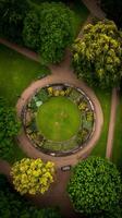 Aerial View of a Circular Garden with Lush Greenery and Benches. photo