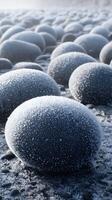Frost Covered Pebbles on a Winter Shore Close Up of Icy Rock Formations. photo
