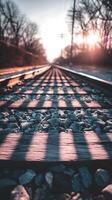 Railroad Tracks at Sunset A Low Angle View of Sunlit Railway Ties and Ballast. photo