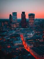 London Cityscape at Sunset Aerial View of Illuminated Skyscrapers and Streets. photo