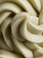 Close Up of Creamy, Swirled Food Texture, Ideal for Culinary or Cosmetic Backgrounds. photo
