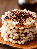 Close up of a Stack of Crispy Rice Cakes Topped with Sweet and Savory Glaze. photo