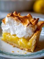 Close up of a slice of lemon meringue pie on a plate. photo