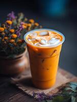 Iced Thai Tea in a Plastic Cup with Flowers. A close up image of a refreshing beverage. photo