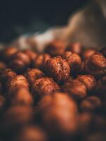 Close Up of Hazelnuts Coated in a Spicy Dust. A Detailed Macro Photograph of Roasted Hazelnuts. photo